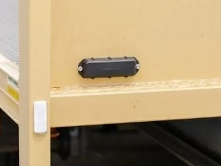 A Barra GPS tracker screwed to a trailer chassis